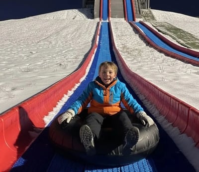 An image of a guest going down the Snowless Tube Hill.