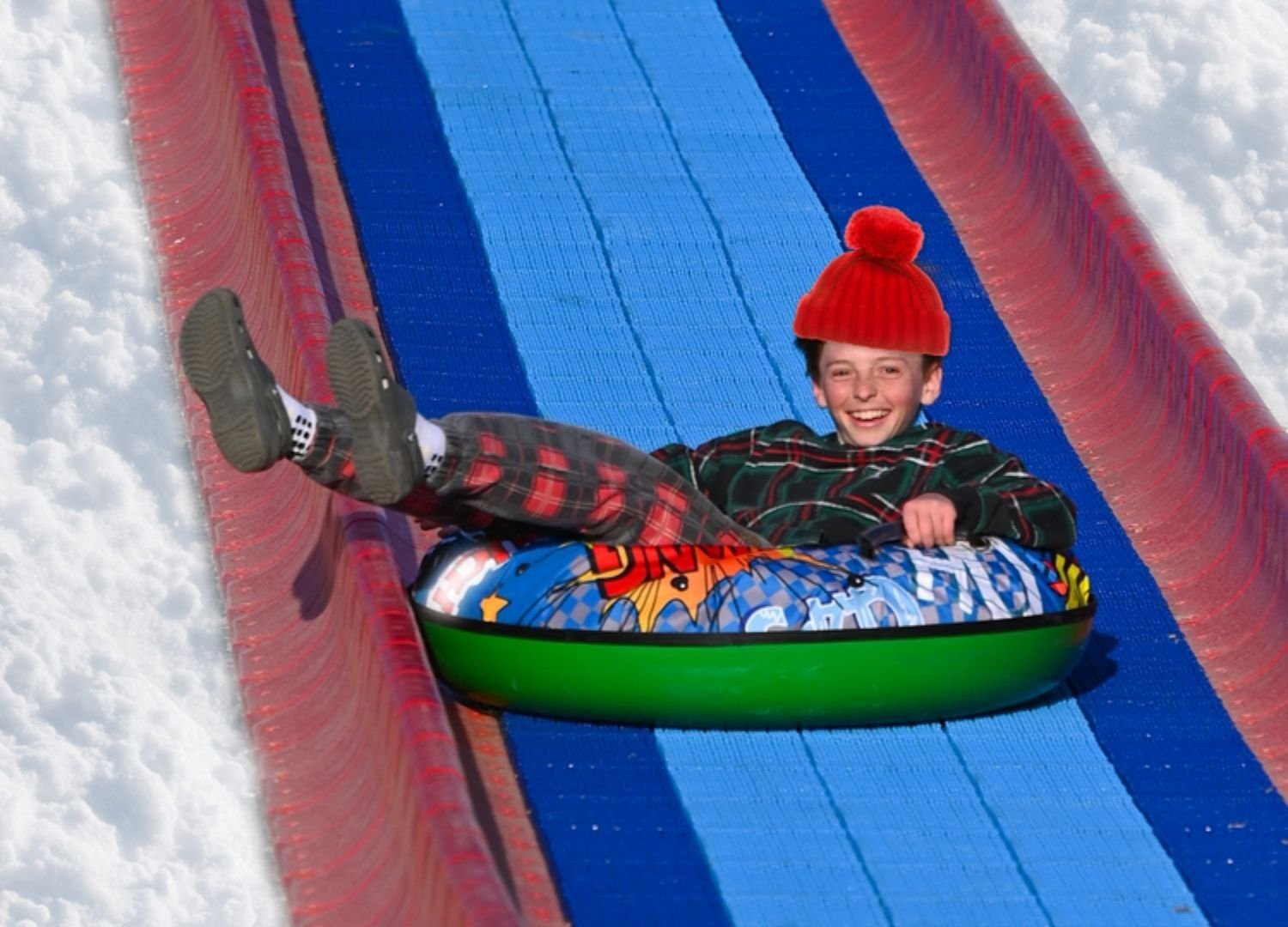 An image of a happy guest sliding down the Tube Hill.