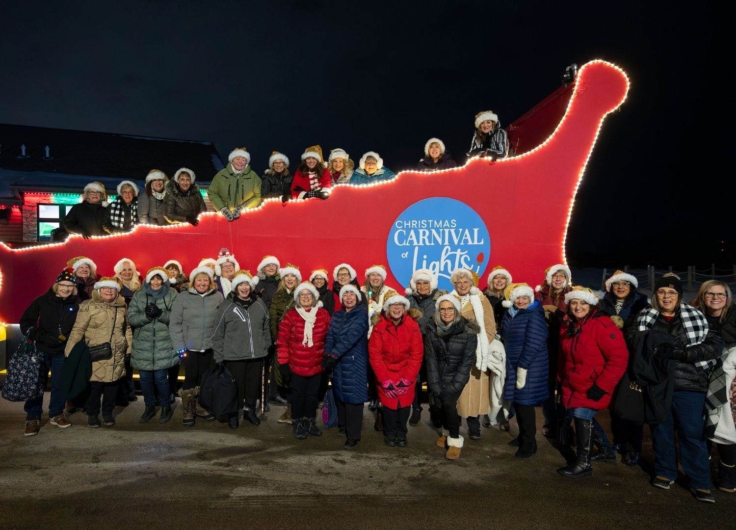 An image of a huge group of people going on Santa's GIANT Sleigh.