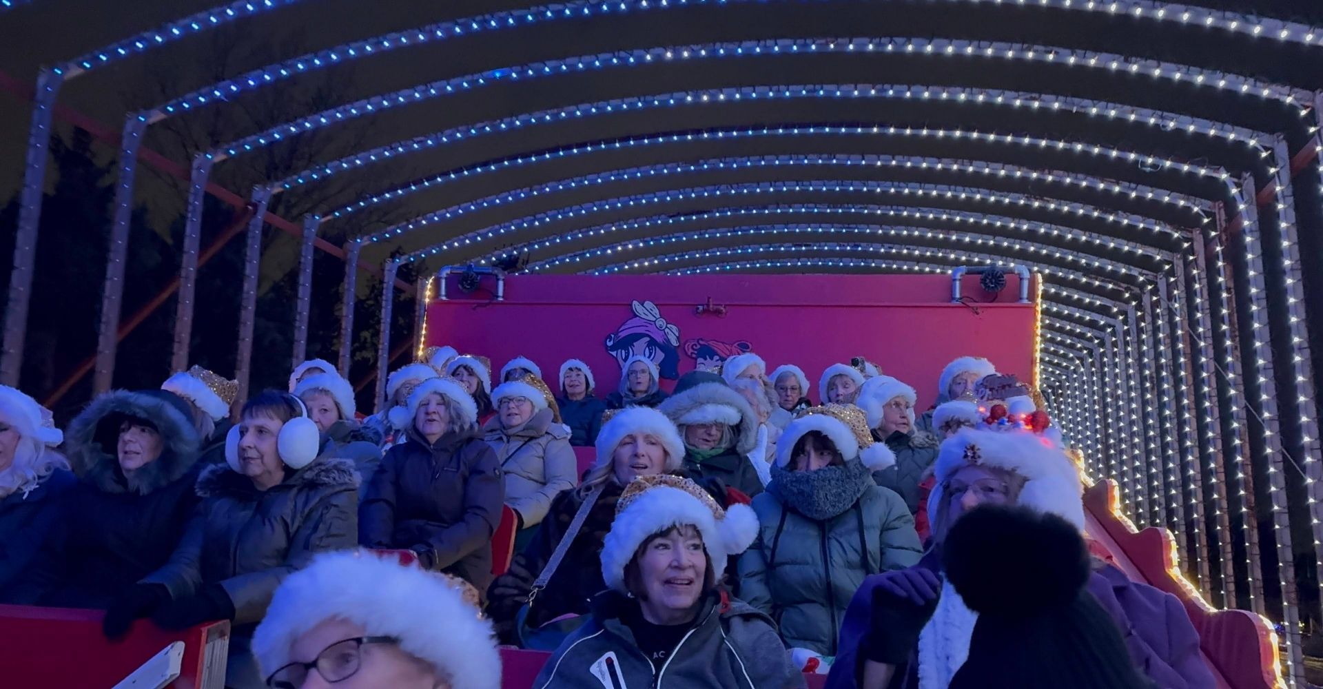 An image of a large crowd of guests on Santa's GIANT Sleigh watching the lights. An image of a large crowd of guests on Santa's GIANT Sleigh watching the lights.