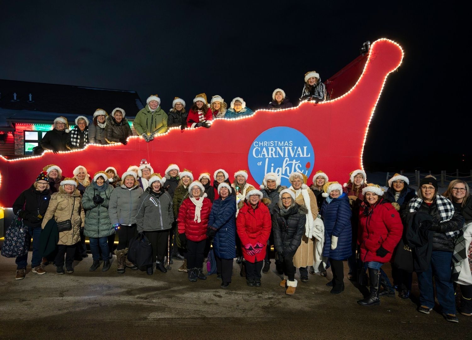 An image of a crowd of guests next to Santa's GIANT Sleigh.