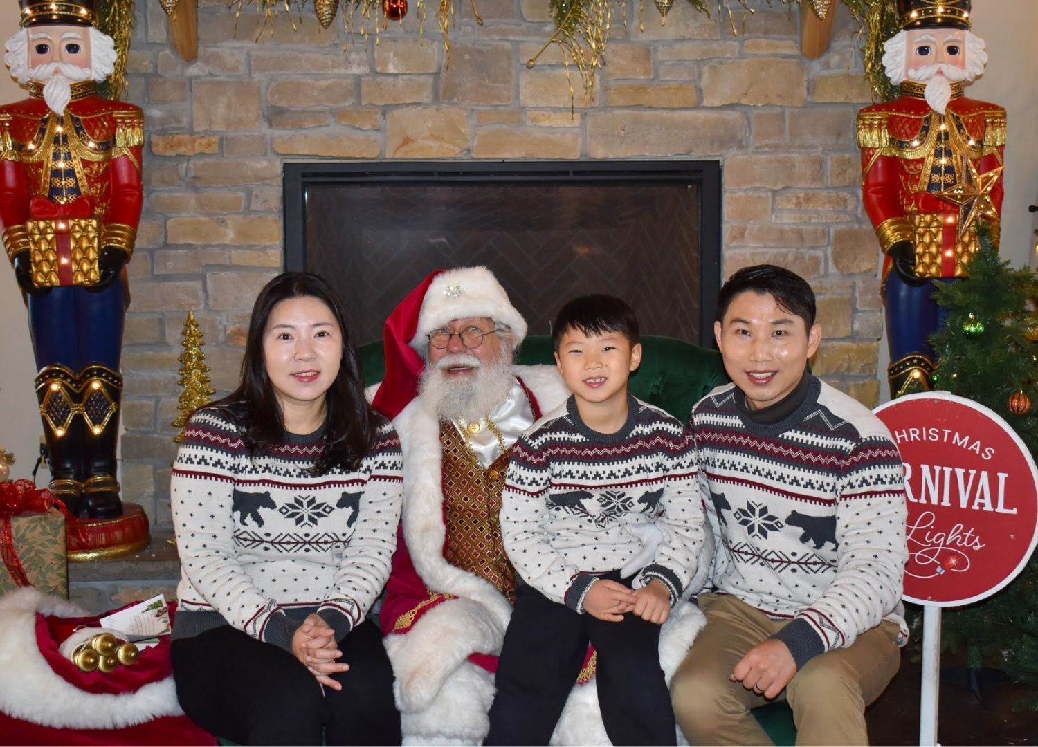An image of a family posing for a picture with Santa at his workshop. An image of a family posing for a picture with Santa at his workshop.